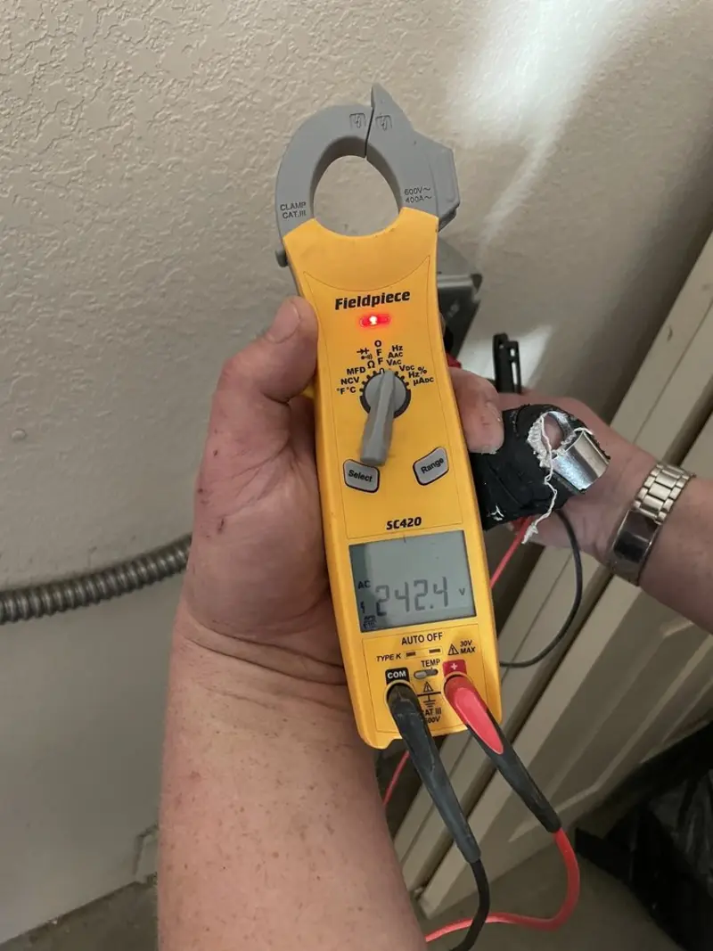Voltage testing with clamp meter during Outlet Installation in Upper Grand Lagoon
